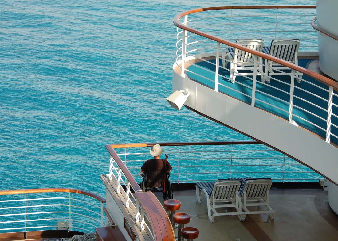 Disabled traveler in wheelchair on modern cruise ship